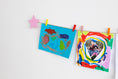Load image into Gallery viewer, Kids art display with pink stars
