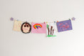 Load image into Gallery viewer, Kids art display with lavender stars
