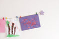 Load image into Gallery viewer, Kids art display with lavender stars
