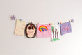 Load image into Gallery viewer, Kids art display with lavender stars
