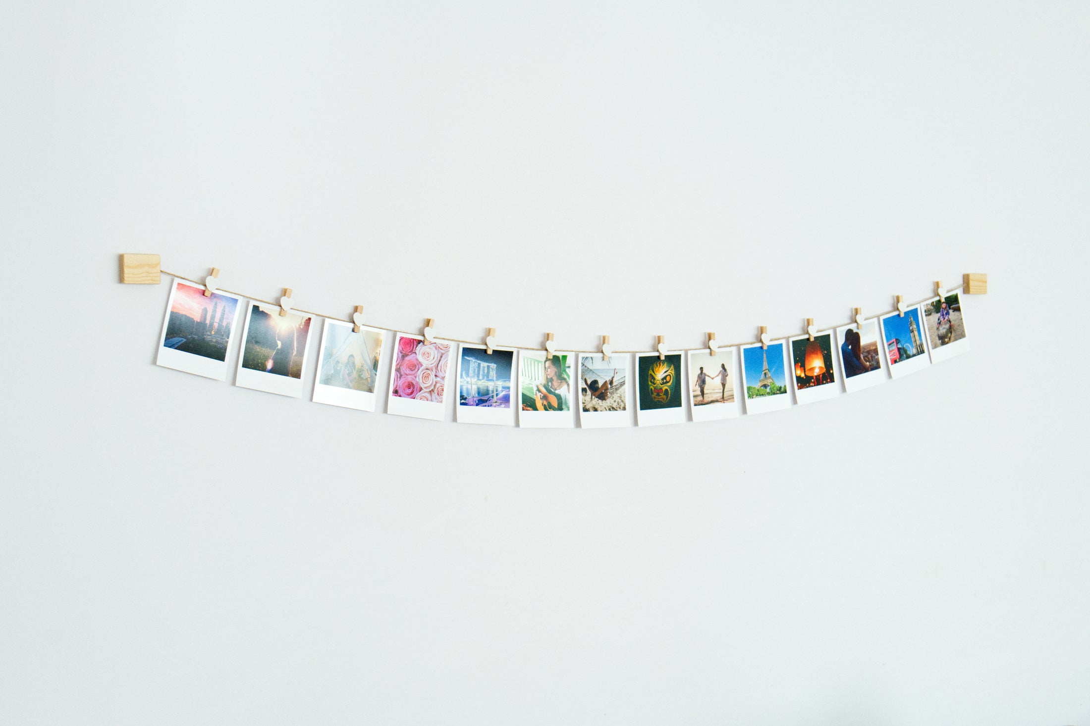White hearts clothes peg photo display