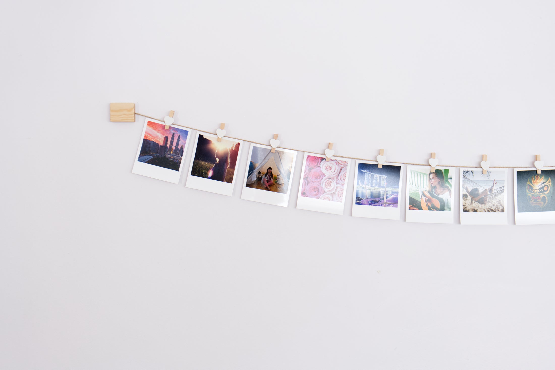 White hearts clothes peg photo display