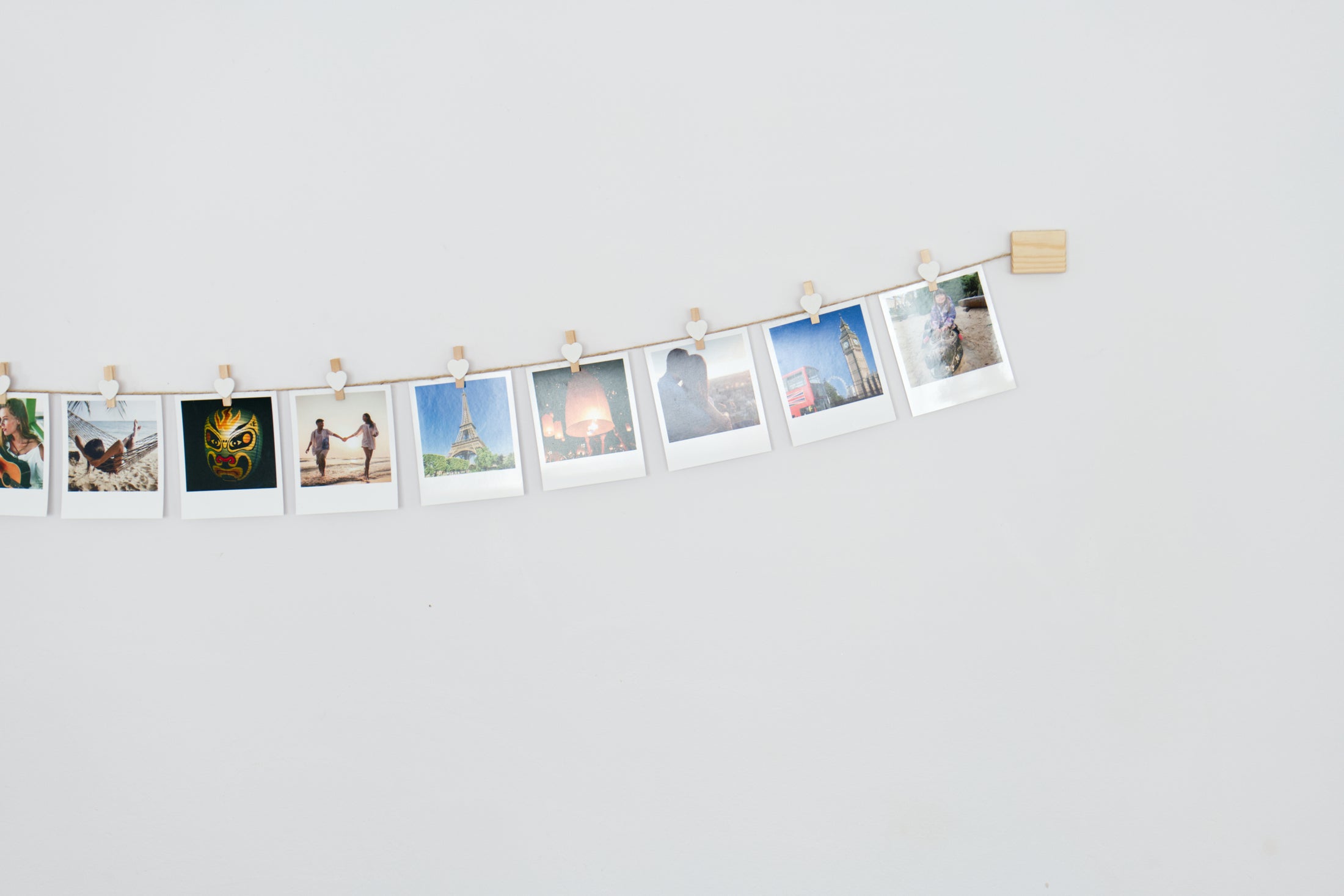 White hearts clothes peg photo display
