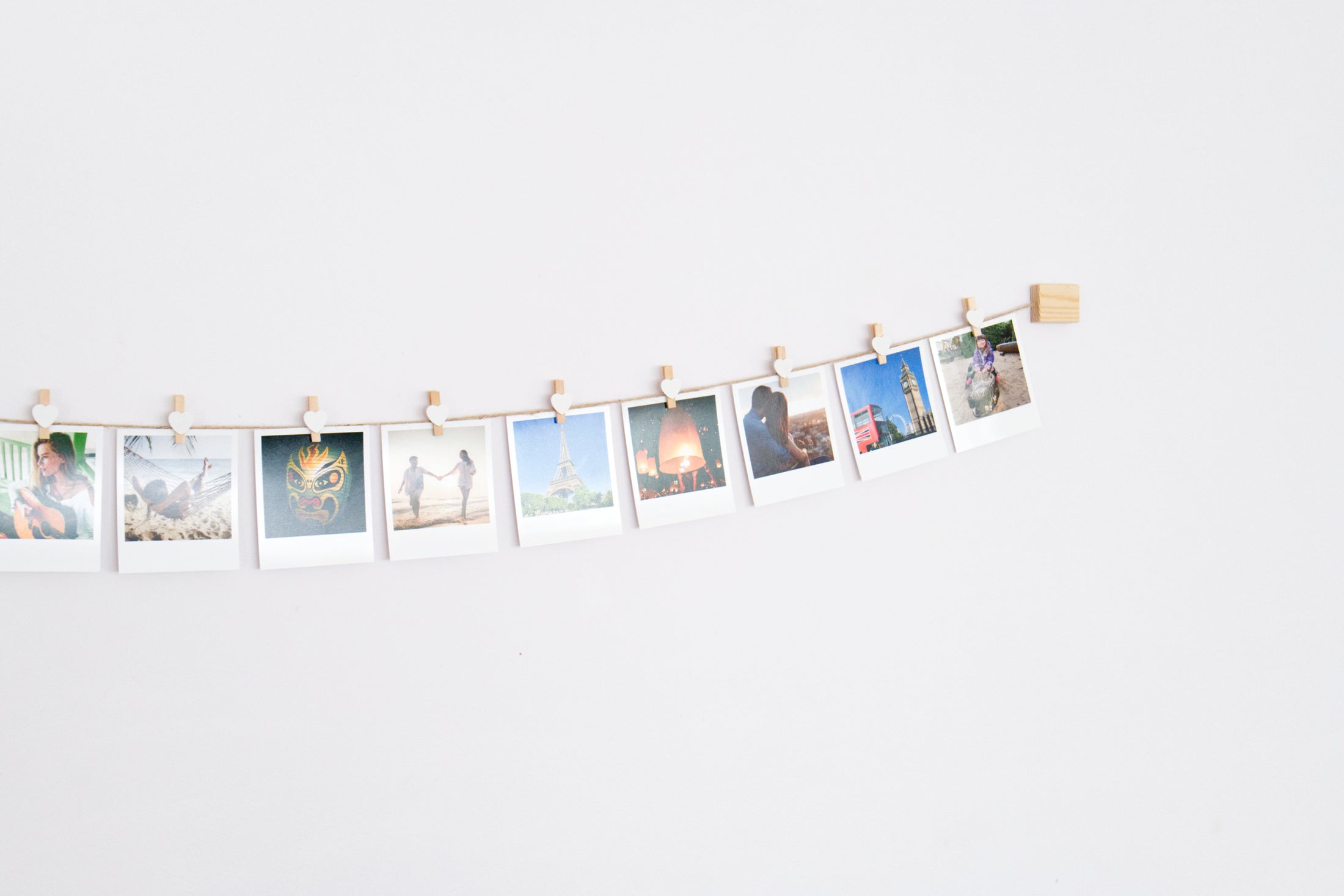 White hearts clothes peg photo display
