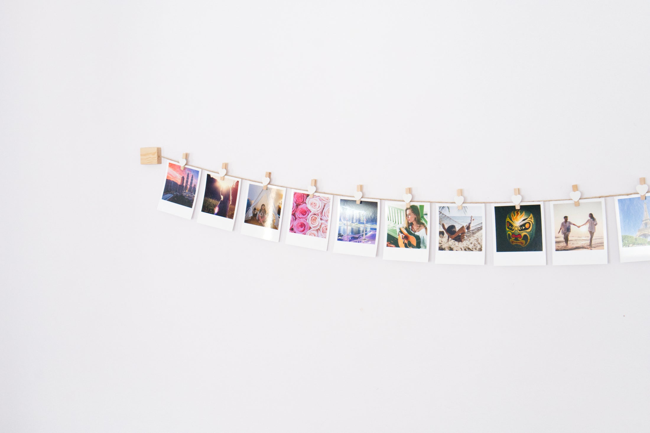 White hearts clothes peg photo display