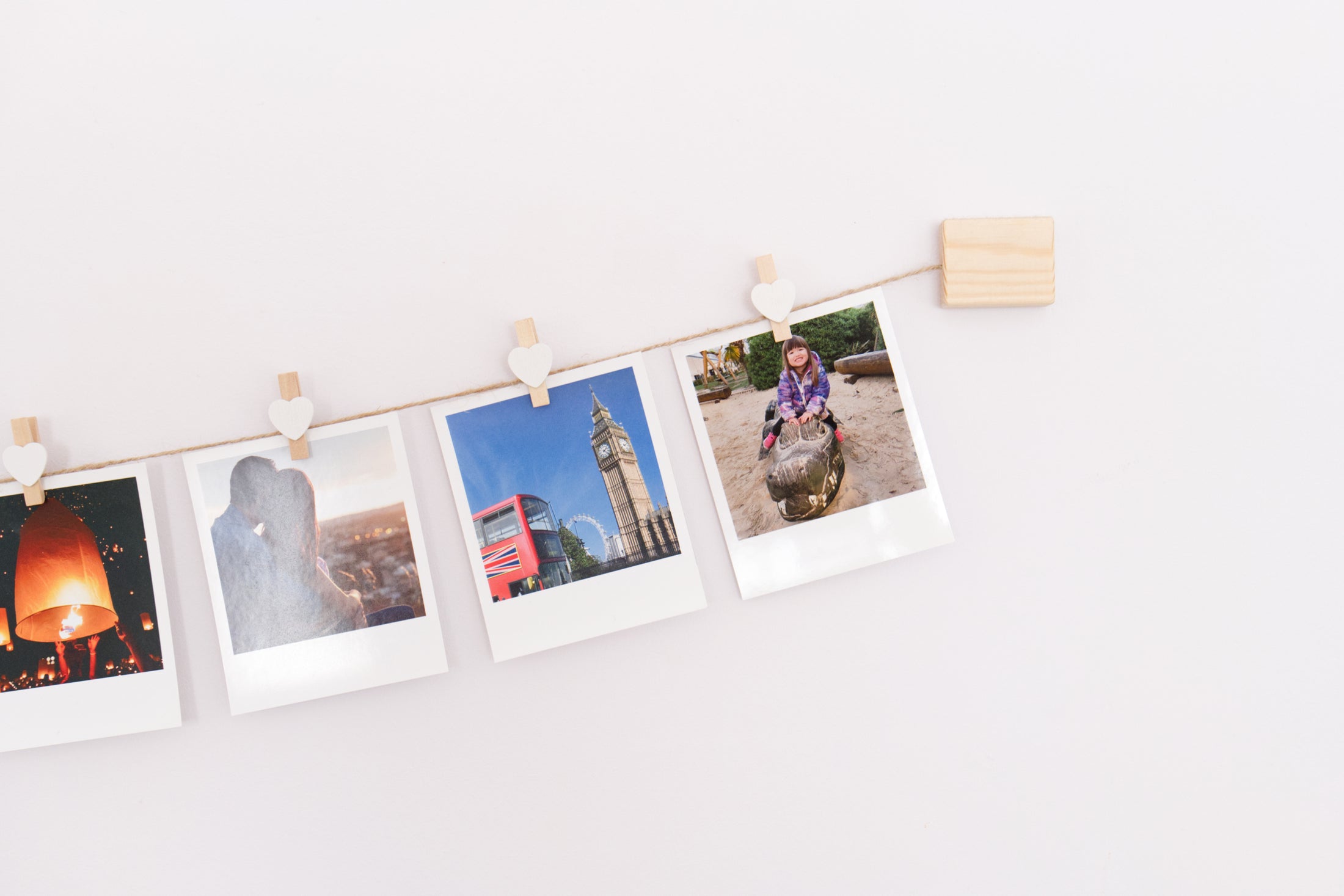 White hearts clothes peg photo display
