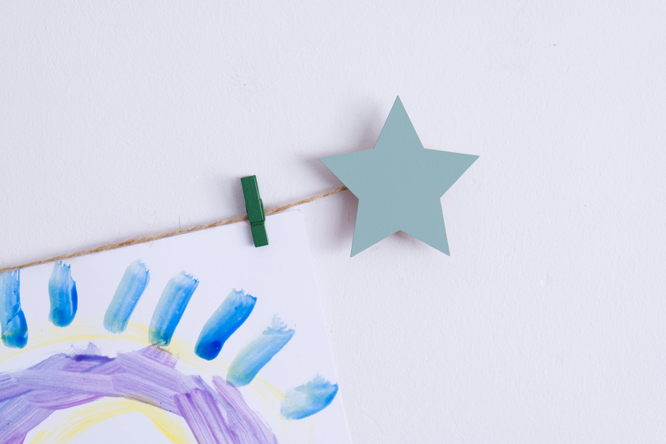 Kids art display with sage green stars