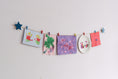 Load image into Gallery viewer, Kids art display with teal stars
