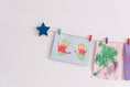 Load image into Gallery viewer, Kids art display with teal stars
