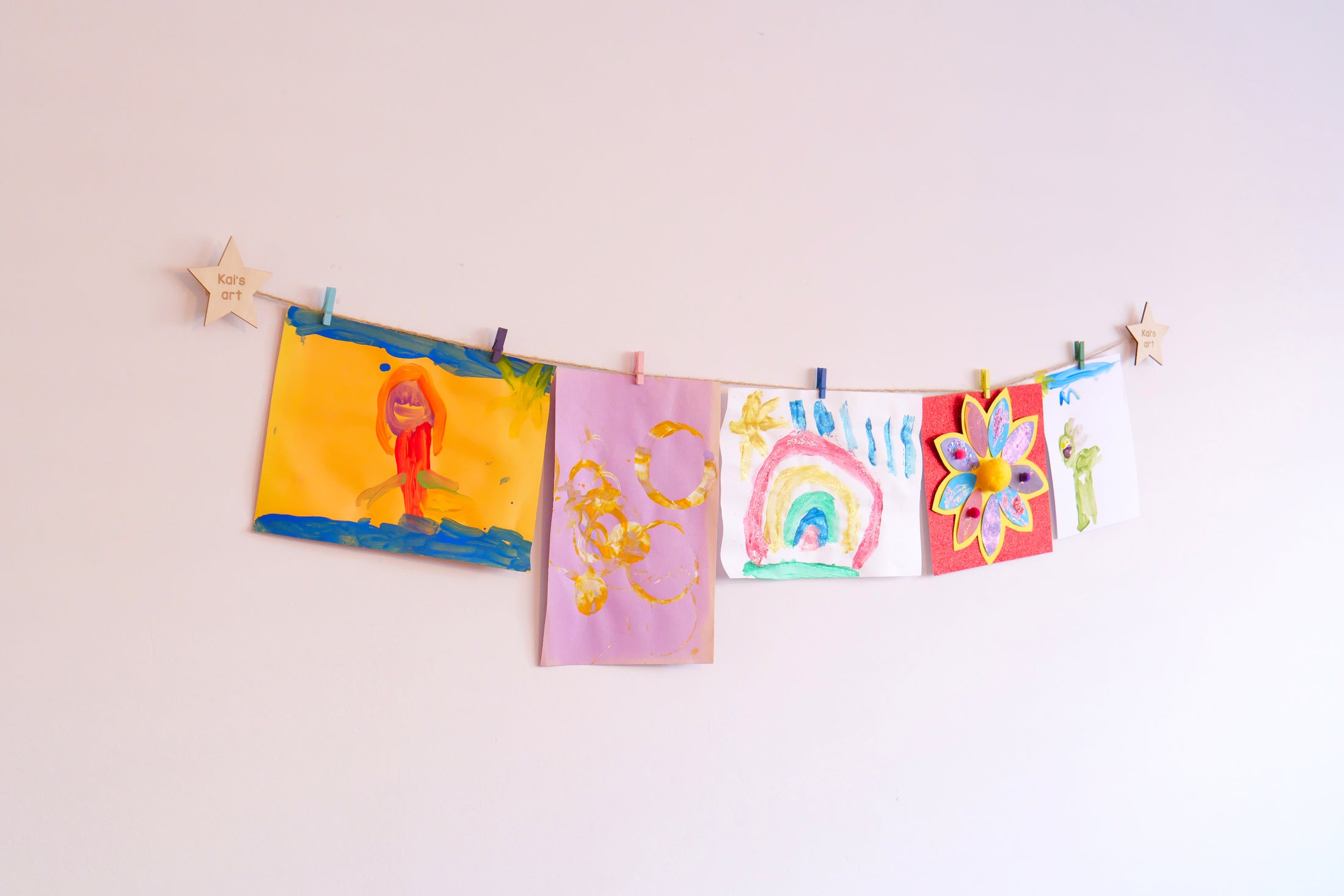 Personalized kids artwork display hanging paintings and craft on a wall 