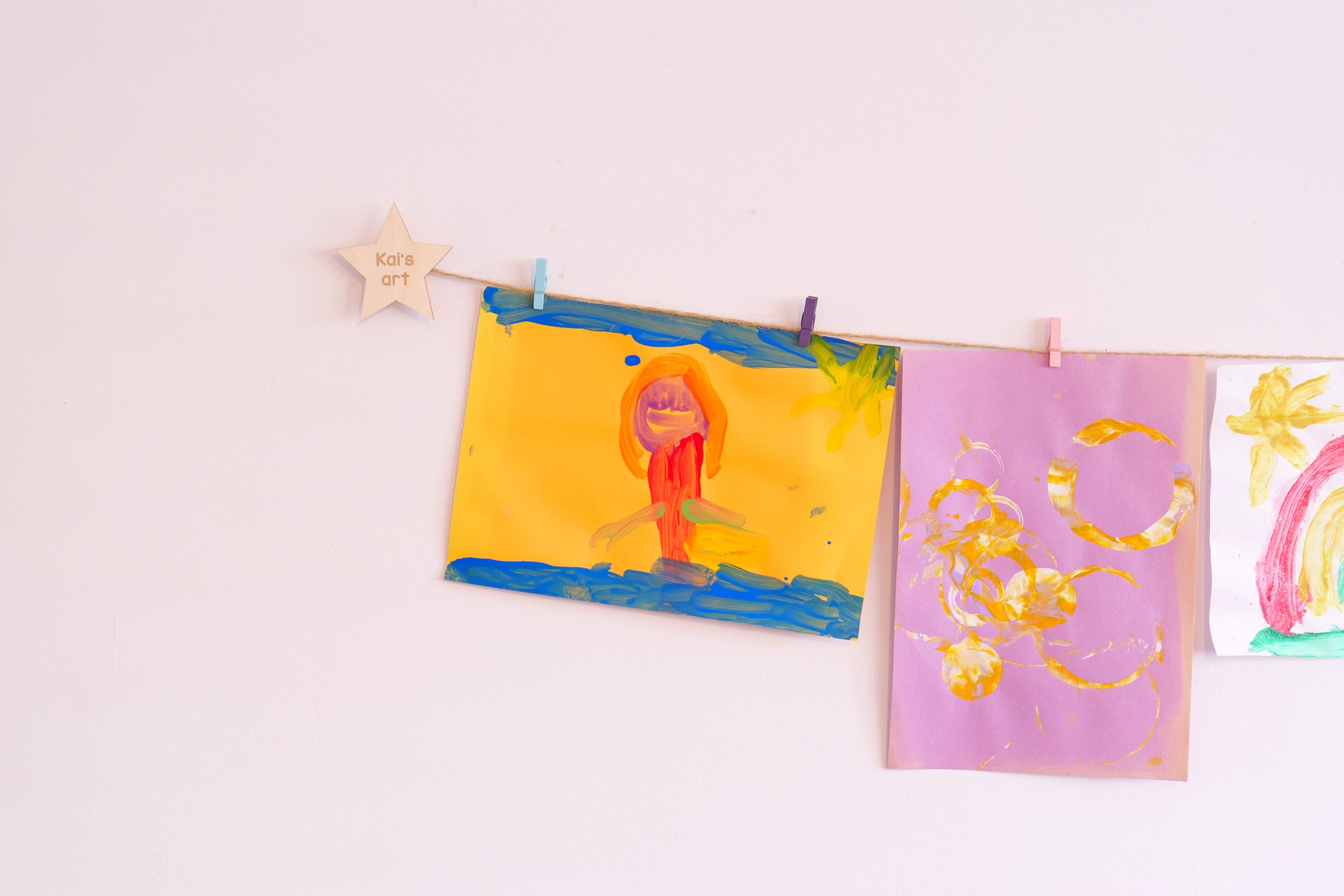 Clothesline art display with personalised wooden star mounts