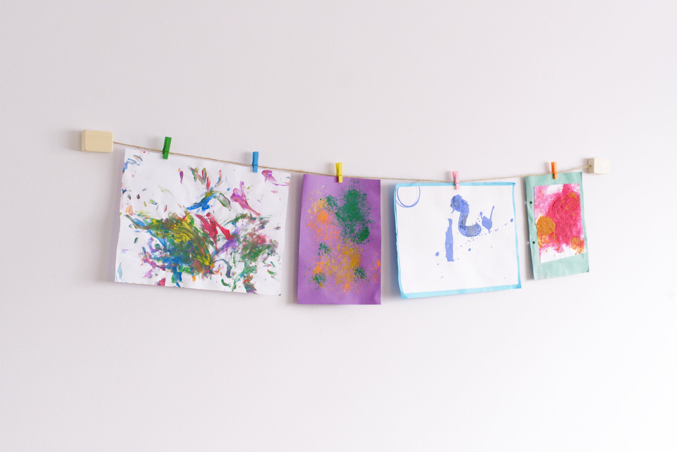 Kids art display with colourful clothes pegs