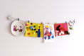 Load image into Gallery viewer, Kids art display with silver stars
