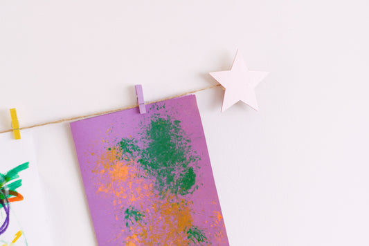 Kids art display with metallic pink stars