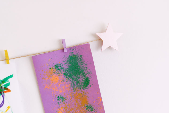 Kids art display with metallic pink stars