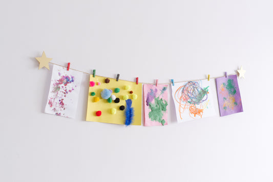 Gold star design art hanger displaying kids crafts on a wall